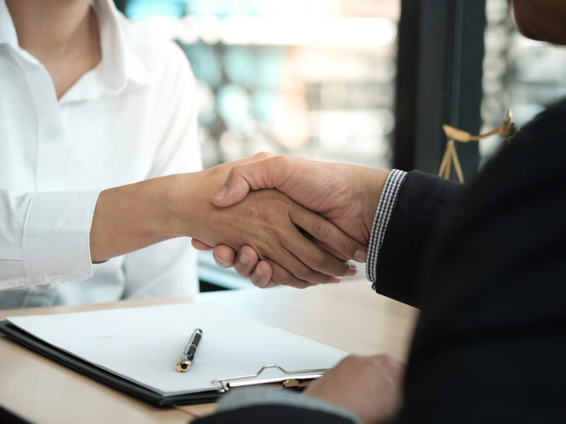 Lawyer handshake with client. Business partnership meeting successful concept